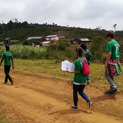 A group of Projects Abroad internship students distributing awareness posters in rural areas during their public health work experience in Madagascar. A photo of internship students from Projects Abroad handing out posters to raise awareness during their public health work experience in Madagascar.